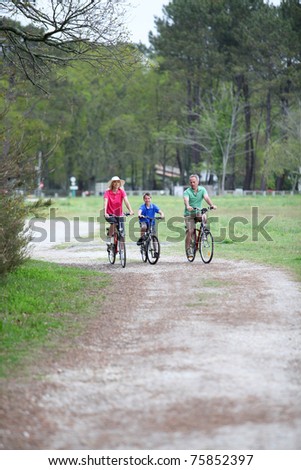 Family riding bicycles in countryside