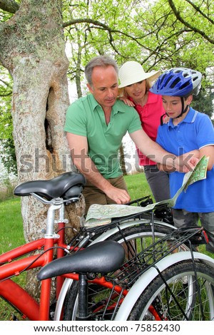 Family on bicycle ride looking at map