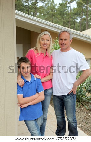 Family standing in front of their house