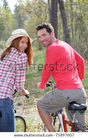 Couple riding bicycles in countryside