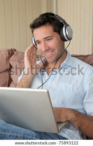 Handsome man listening to music on internet