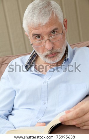 Portrait of senior man reading a book