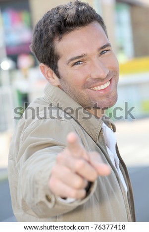Portrait of handsome man pointing at camera