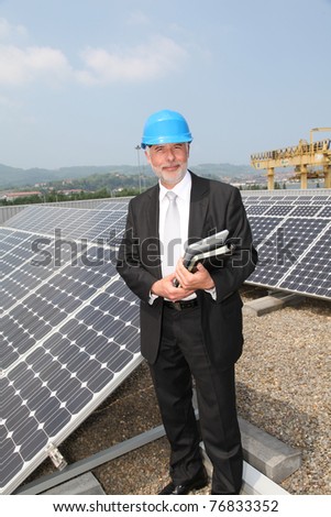 Businessman checking photovoltaic installation