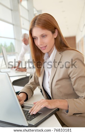 Smiling businesswoman in front of laptop