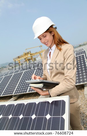 Woman engineer checking solar panels setup