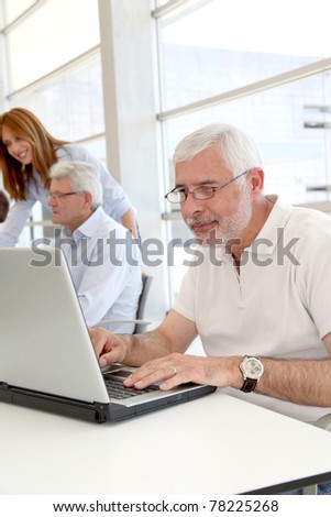 Senior man working on laptop computer