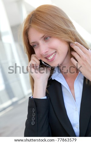 Beautiful saleswoman talking on mobile phone