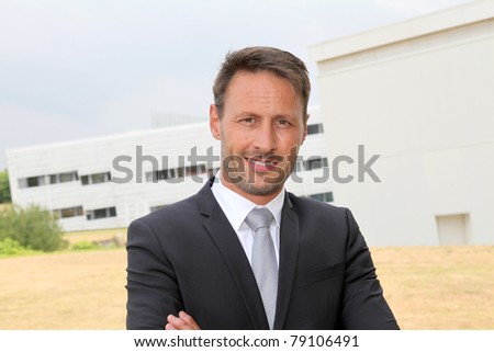 Portrait of smiling businessman in dark suit