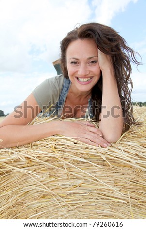 Beautiful woman laying down bale