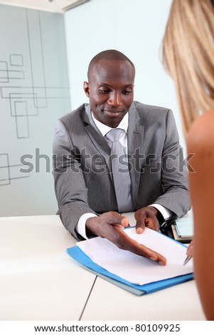 Businessman having client signing contract