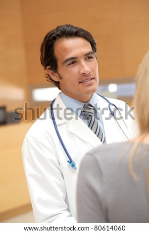 Portrait of handsome doctor in hospital hall