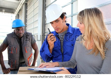 Manager with store men controlling goods delivery