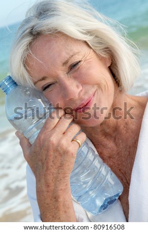 Senior woman drinking water from bottle