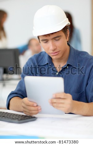 Student in architecture using electronic tablet