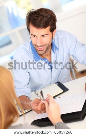 People in office signing contract