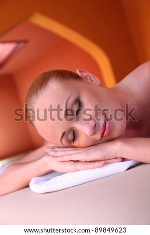 Portrait of woman laying on massage bed