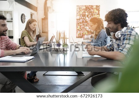 Trendy young people working in co-working office