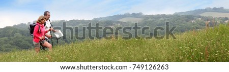 Senior couple hiking in natural landscape - banner template web