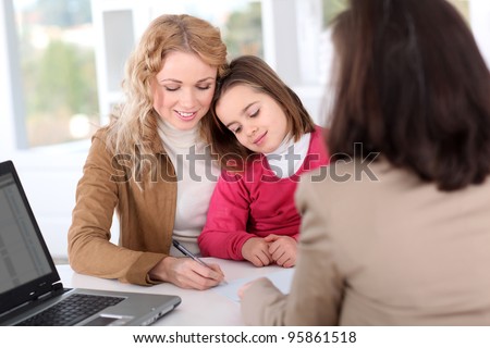 Woman in real-estate agency with kid