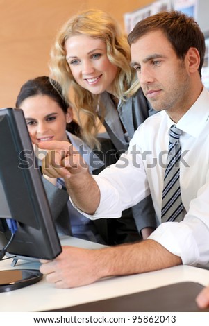 Business meeting in front of desktop computer