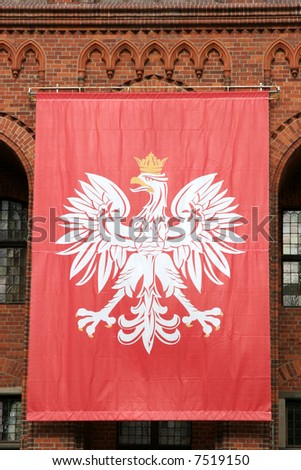 Polish national flag hanging on an old Gothic wall