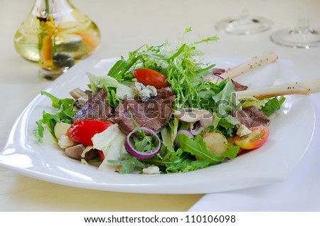 fresh salad with beef tongue and blue cheese