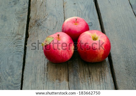 red apples on wood in a rainy day