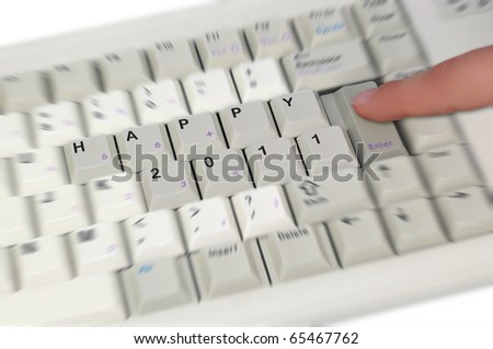 Keyboard with text HAPPY 2011 and finger pushing the enter button
