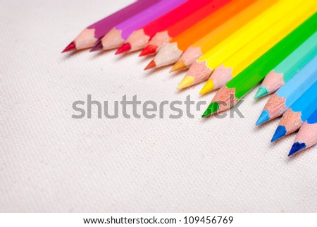 Colorful pencil crayons on the background fabric