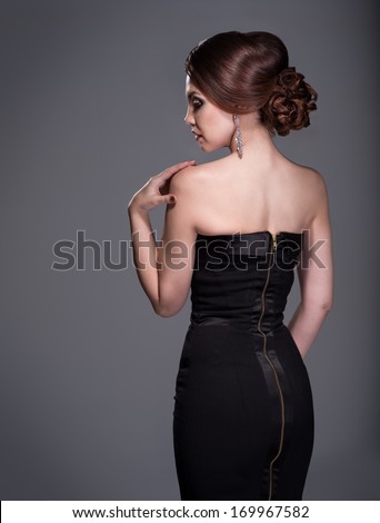 Woman in evening dress with beautiful hairstyle from the back