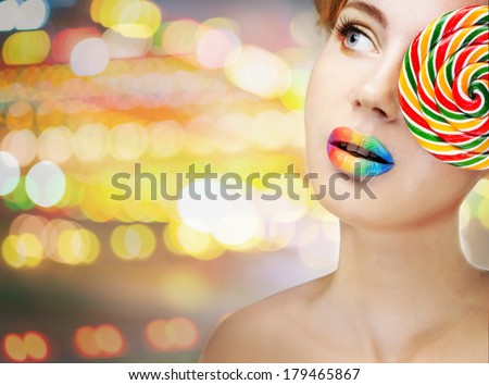 woman with bright makeup and candy