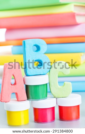 letters abc and stack of books on a white background