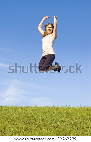 Girl in a jump in the blue sky