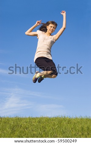 Girl in a jump in the blue sky