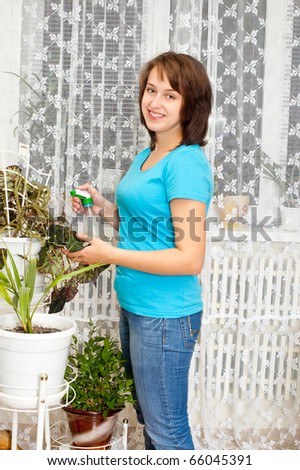 The girl looks after flower  of the house