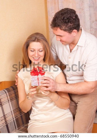 The man gives a gift to the woman