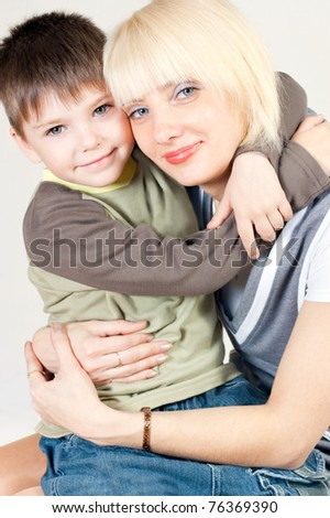 Young mother hugging her son