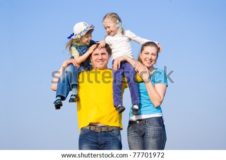 A family with two children at the background of the sky