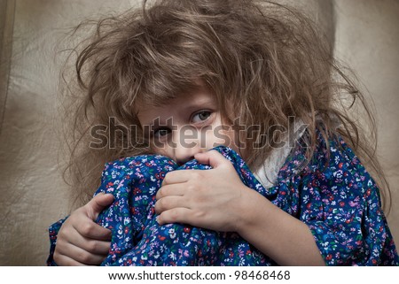 Sad little girl hides her face