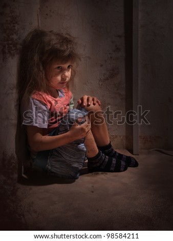 child alone in a dark corner