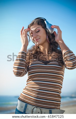 girl in headphones on the sea