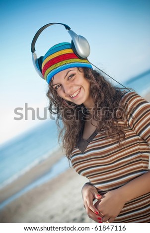 girl in headphones on the sea
