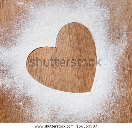 The heart of the flour on the table from the old boards. dramatic light
