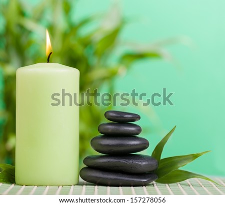 Zen basalt stones and candle on the wood