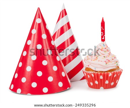 Small cupcake with candle and red party hat