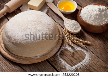 Easter concept. The dough is made from flour and heart on the table from the old boards