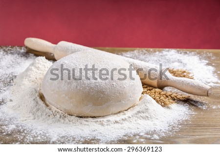 wooden rolling pin with dough.