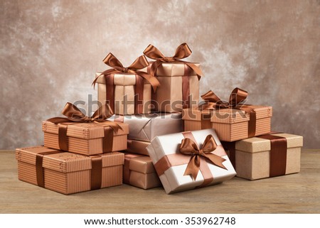 Gold box with gifts and brown bow.