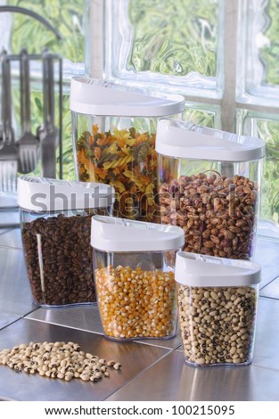 Plastic containers holding different types of  grains